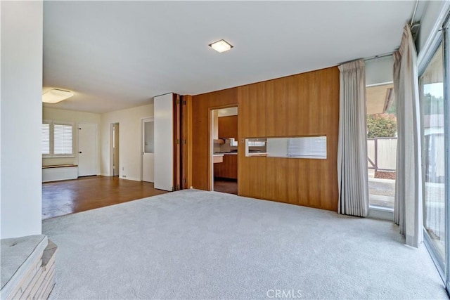 2175 Queensberry Rd, Pasadena, CA 91104 - unfurnished living room with carpet flooring and wood walls