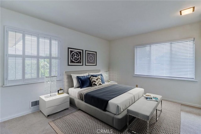 bedroom featuring carpet and baseboards