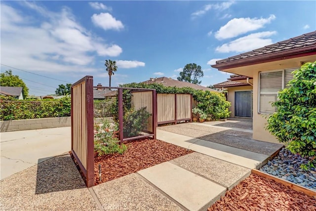 view of yard with fence and a patio
