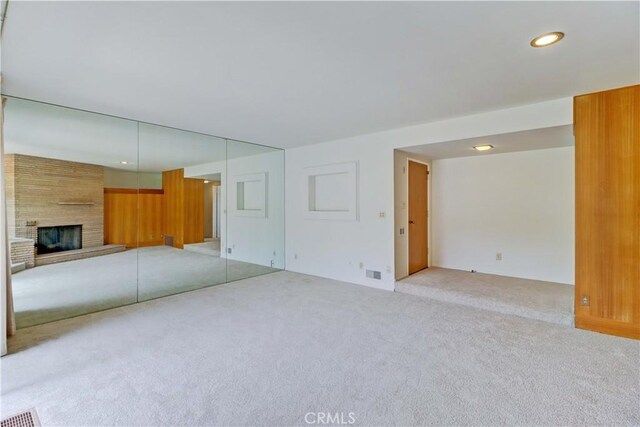 2175 Queensberry Rd, Pasadena, CA 91104 - unfurnished living room with carpet flooring, a fireplace, and recessed lighting