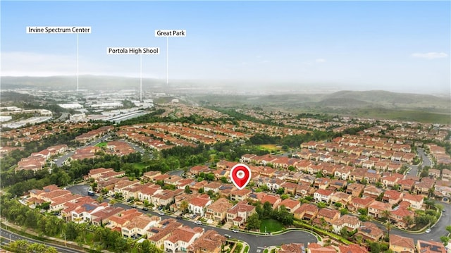 aerial view of property's location featuring nearby suburban area and mountains