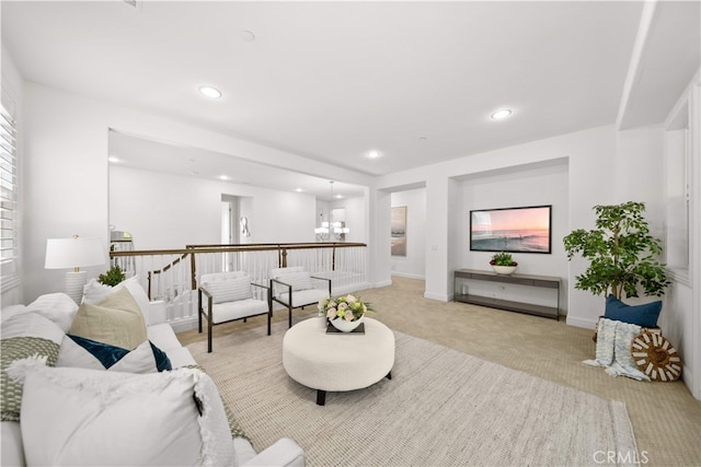 living room featuring light colored carpet, a chandelier, recessed lighting, and baseboards
