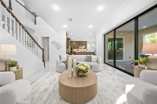 living area featuring light marble finish floors, recessed lighting, stairs, and baseboards