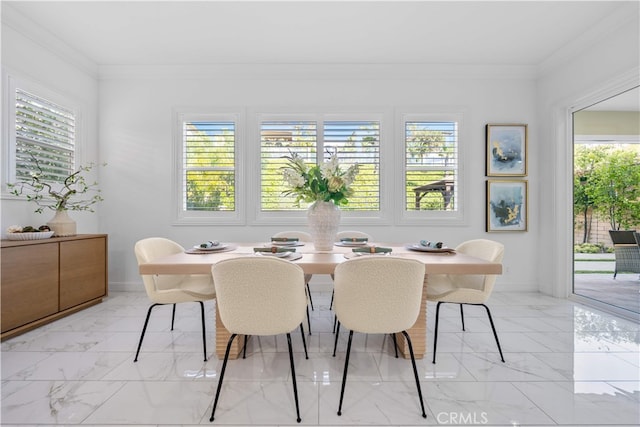 dining room with light marble finish floors, plenty of natural light, baseboards, and crown molding