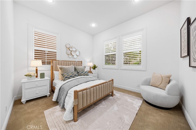 bedroom featuring light colored carpet, baseboards, and recessed lighting