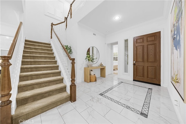 entrance foyer with marble finish floors, stairway, ornamental molding, baseboards, and recessed lighting