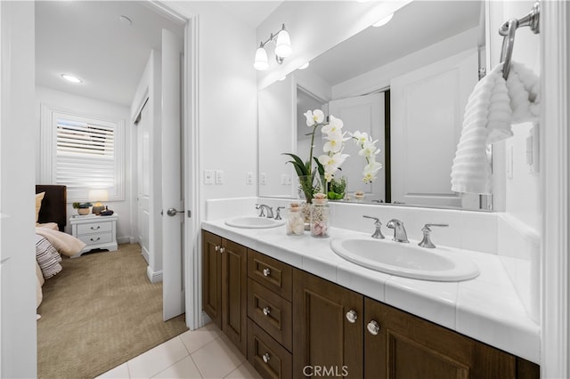 full bathroom featuring double vanity, tile patterned floors, and baseboards