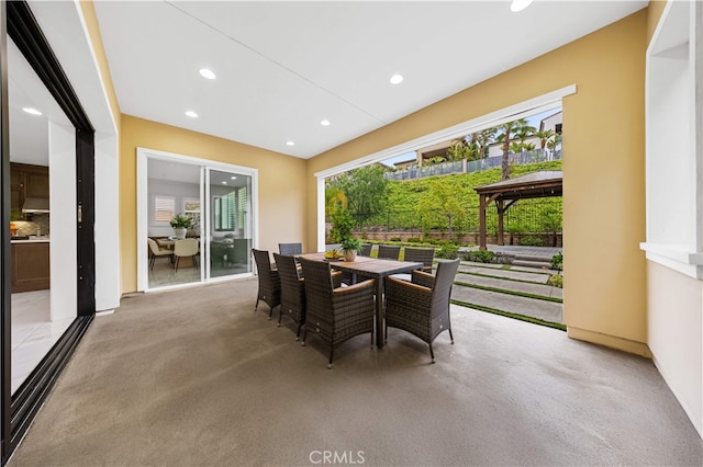 dining room with recessed lighting and carpet
