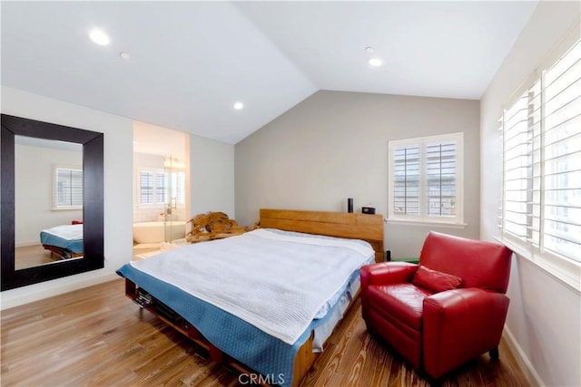 bedroom with wood finished floors, lofted ceiling, multiple windows, and recessed lighting