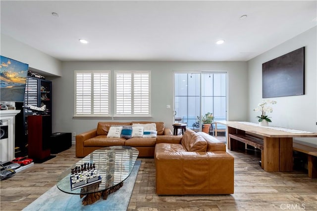 living room with wood finished floors and recessed lighting