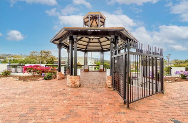 view of patio / terrace with a gate, a gazebo, and fence