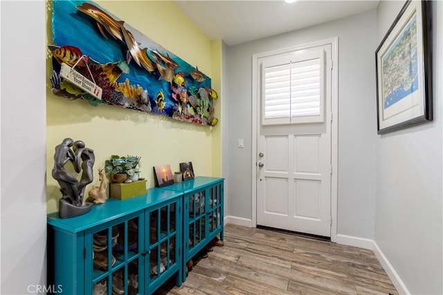 entryway featuring wood finished floors and baseboards