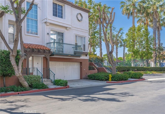 12671 Nicklaus Ln, Tustin, CA 92782 - view of front facade with stucco siding, driveway, a garage, and a tile roof