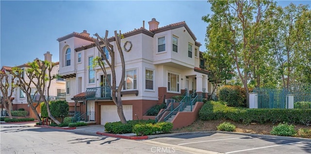 12671 Nicklaus Ln, Tustin, CA 92782 - view of property with an attached garage, stairway, and central AC unit