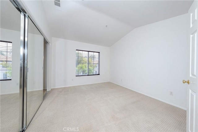 12671 Nicklaus Ln, Tustin, CA 92782 - unfurnished bedroom featuring vaulted ceiling, a closet, light carpet, and baseboards