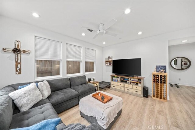 living area featuring a ceiling fan, light wood-type flooring, recessed lighting, and baseboards