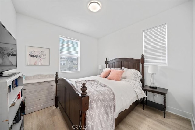 bedroom featuring light wood-style flooring and baseboards