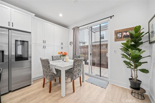 dining space with light wood finished floors, baseboards, and recessed lighting