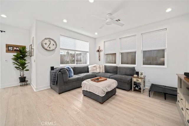 living room featuring a ceiling fan, light wood-type flooring, recessed lighting, and baseboards