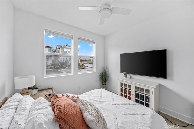 bedroom featuring baseboards and ceiling fan