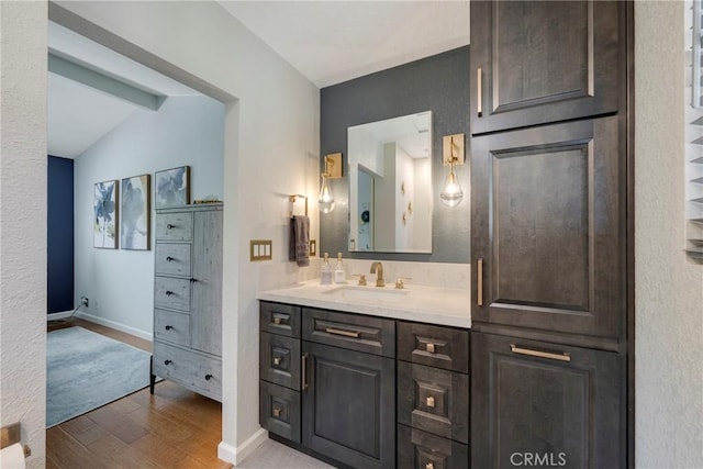 6060 E Summit Ct, Anaheim Hills, CA 92807 - bathroom with wood finished floors, vanity, lofted ceiling, and baseboards