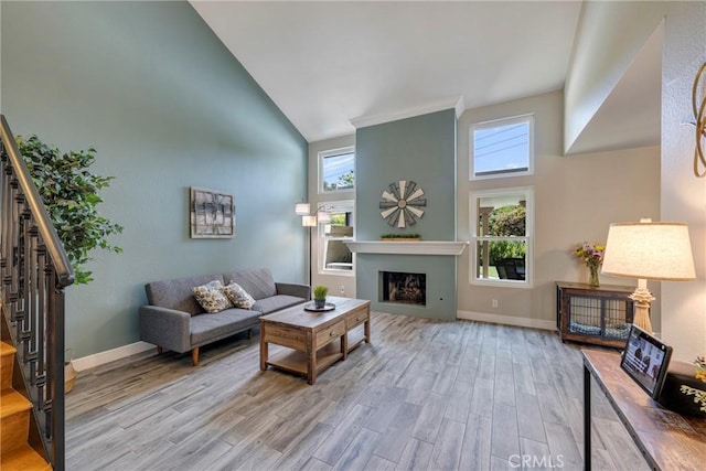 6060 E Summit Ct, Anaheim Hills, CA 92807 - living room featuring high vaulted ceiling, stairs, wood finished floors, a fireplace, and baseboards