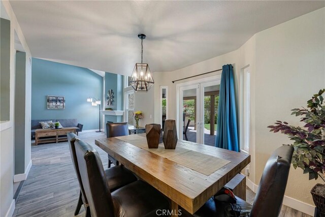 6060 E Summit Ct, Anaheim Hills, CA 92807 - dining room with baseboards, wood finished floors, french doors, and a chandelier