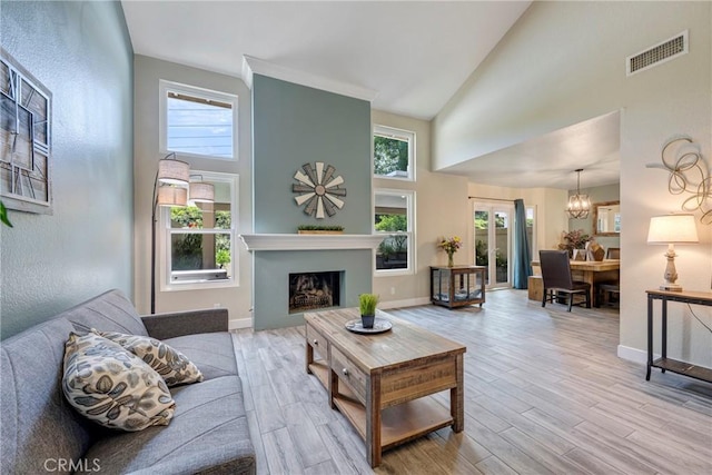 6060 E Summit Ct, Anaheim Hills, CA 92807 - living room featuring high vaulted ceiling, wood finished floors, plenty of natural light, and a fireplace
