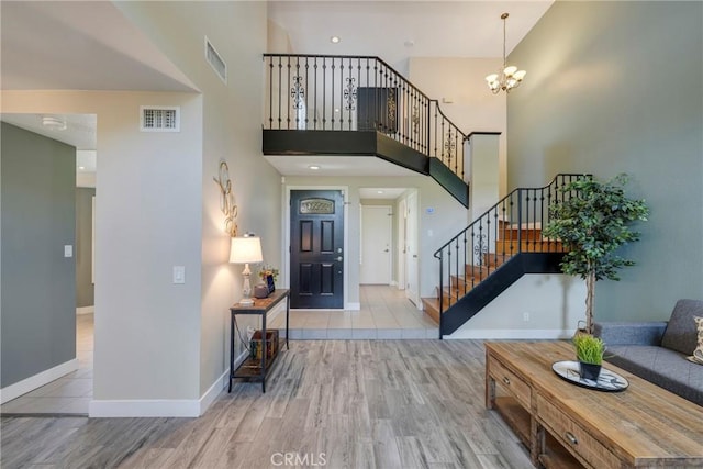 6060 E Summit Ct, Anaheim Hills, CA 92807 - entryway featuring stairway, wood finished floors, a chandelier, a high ceiling, and baseboards