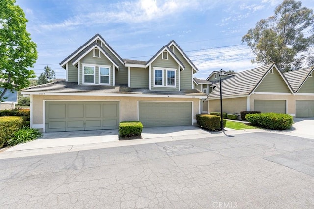 6060 E Summit Ct, Anaheim Hills, CA 92807 - view of front facade with stucco siding, driveway, and a garage
