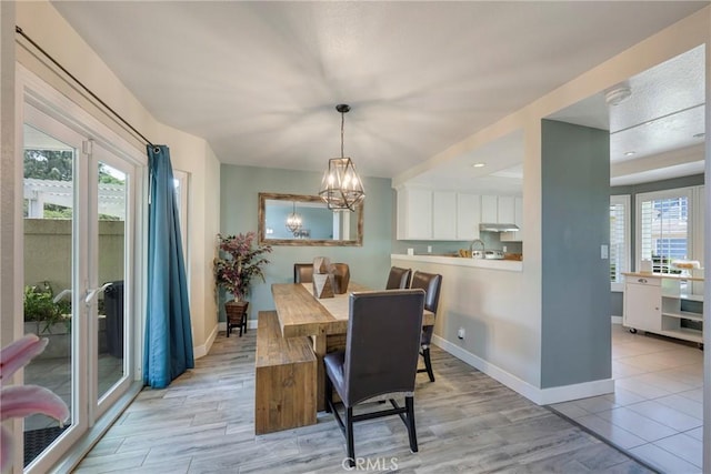 6060 E Summit Ct, Anaheim Hills, CA 92807 - dining space featuring baseboards, a chandelier, and light wood-style floors