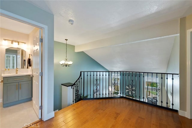 6060 E Summit Ct, Anaheim Hills, CA 92807 - bonus room featuring a sink, a chandelier, light wood-type flooring, baseboards, and arched walkways