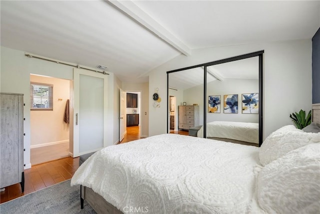 6060 E Summit Ct, Anaheim Hills, CA 92807 - bedroom featuring wood finished floors, baseboards, a closet, and a barn door