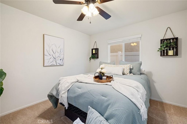 carpeted bedroom featuring baseboards and ceiling fan