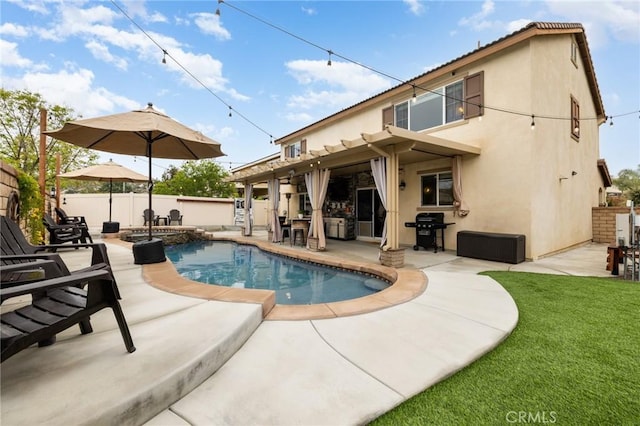 view of swimming pool featuring grilling area, a patio, and a pool with connected hot tub