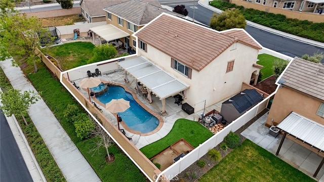 aerial view of property and surrounding area with a pool area