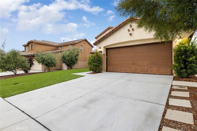 mediterranean / spanish-style house with stucco siding, driveway, a front yard, and an attached garage