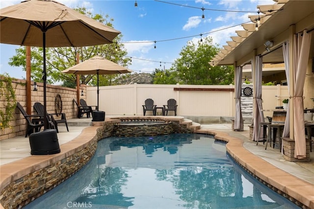view of swimming pool featuring a fenced backyard, a patio area, and a pool with connected hot tub