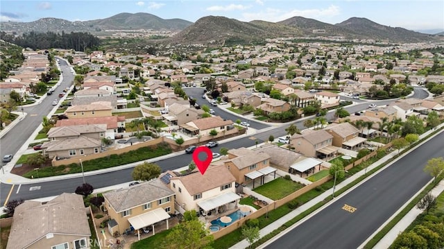 aerial view of property and surrounding area with nearby suburban area and mountains