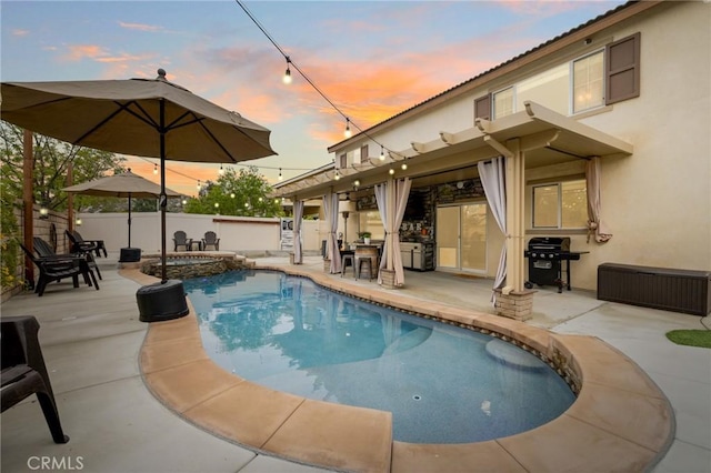 view of pool featuring area for grilling, a patio area, a fenced backyard, and a pool with connected hot tub
