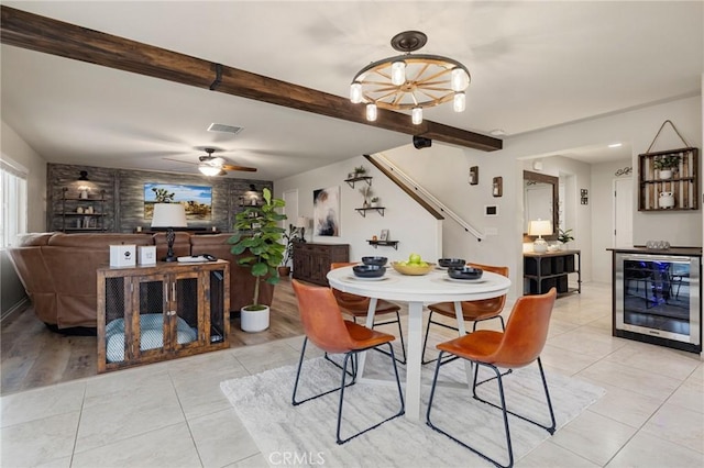 dining room with beverage cooler, light tile patterned floors, beam ceiling, and a ceiling fan