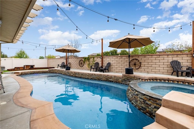 view of pool featuring a patio, a fenced backyard, and a pool with connected hot tub