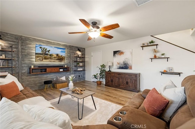 living area with ceiling fan and wood finished floors