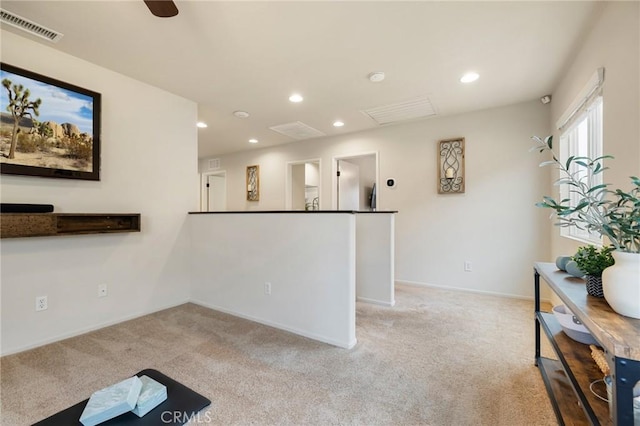 kitchen with light carpet, recessed lighting, and baseboards