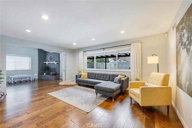 812 N Fern St, Orange, CA 92867 - living area with healthy amount of natural light, hardwood / wood-style floors, a brick fireplace, recessed lighting, and baseboards