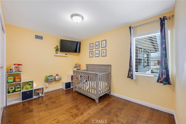 812 N Fern St, Orange, CA 92867 - bedroom with wood finished floors, baseboards, and a crib