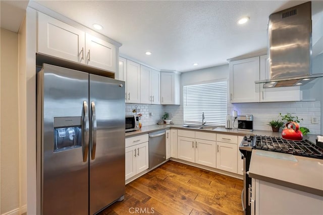 812 N Fern St, Orange, CA 92867 - kitchen featuring stainless steel appliances, island exhaust hood, a sink, dark wood finished floors, and backsplash