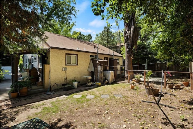 1001 Salem St, Chico, CA 95928 - rear view of property with stucco siding and fence