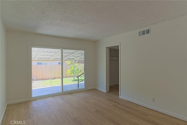 12406 Benson Ave, Chino, CA 91710 - unfurnished room with wood finished floors, baseboards, and a textured ceiling