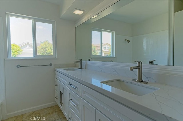 12406 Benson Ave, Chino, CA 91710 - bathroom with healthy amount of natural light, a shower, double vanity, and baseboards